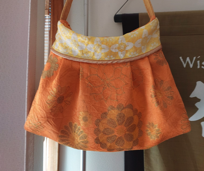 orange bag with gold details